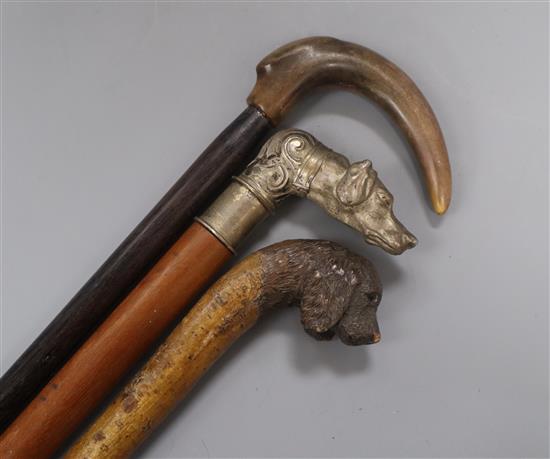 Two dogs head handled canes and another